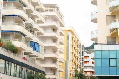 Modern apartment building in Mediterranean style in Albania on the sea coast. Concept of selling a house abroad, renting apartments clipart