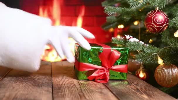 Hand Santa Claus White Glove Puts Gift Christmas Tree Background — Stock Video