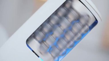 Close-up of a cosmetologist holding a lymphatic drainage massager for weight loss in a beauty clinic. A doctor using an endospheric therapy device for a client