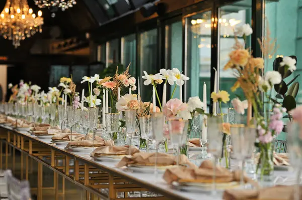 beautiful elegant decor of flowers and elegant serving on the wedding table. Modern wedding decoration