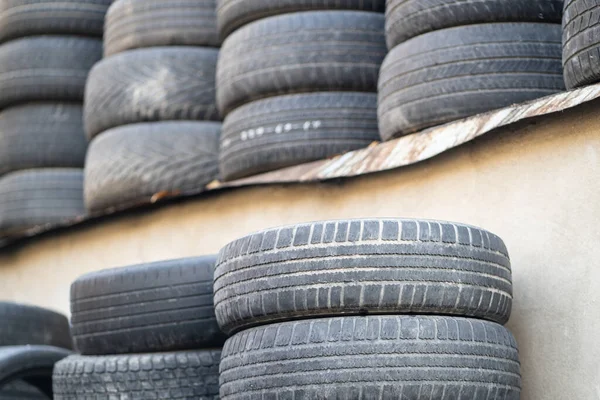 stock image Old used rubber tires stacked with high piles. Tyre dump. Hazardous waste requiring recycling and disposal. 