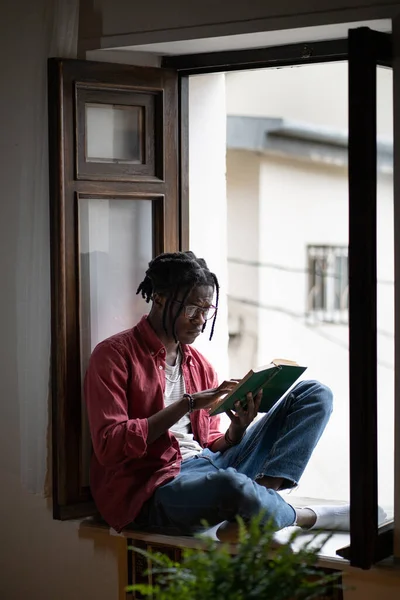 Pensive African American Young Man Eyeglasses Reading Sad Book Sitting — Stock Photo, Image