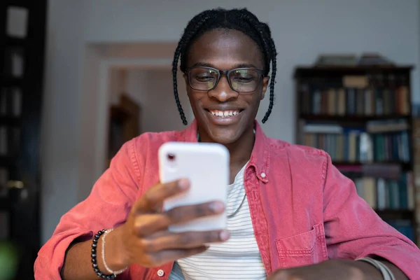 Беззаботный Афроамериканец Сидит Столом Учится Мобильном Телефоне Счастливый Молодой Чернокожий — стоковое фото