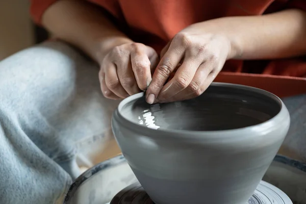 stock image Close up of female hands molding wet clay on wheel, shaping final pottery product, potter making unique handmade stoneware, selective focus. Stress-relieving hobbies, ceramics and mental heath