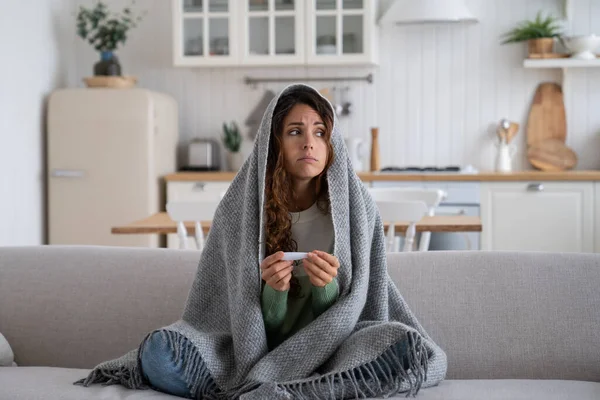 Young Worried Anxious Sick Woman Sitting Covered Blanket Sofa Holding — Stock Fotó