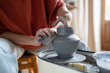 Master hands making clay jug. Closeup sculptor in workshop formed ceramic vase or earthenware on potters wheel. Interest activity brings income. Handicrafts master class for relax and stress relive. clipart