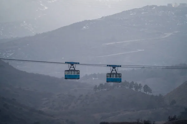 Two Blue Old Cabins Cable Car Moves Backdrop Crested Mountains — Stock Photo, Image