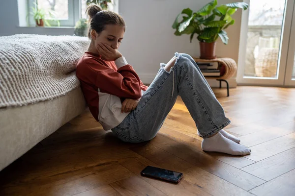 Offended Unhappy Teenage Girl Sadly Looking Phone Sits Floor Home — Stock Photo, Image