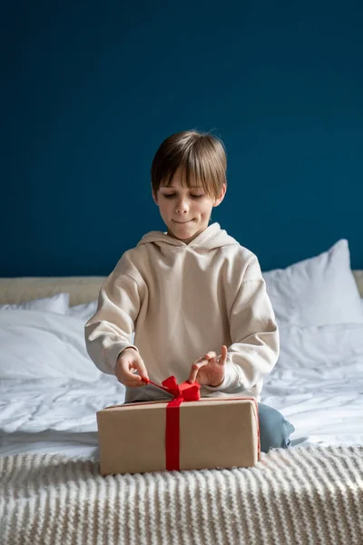 Interested Curious Child Boy Carefully Unties Bow Gift Box While — Stock Photo, Image