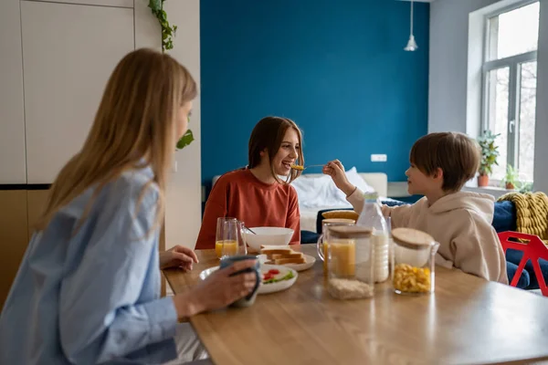Pleased Preschooler Boy Holds Out Spoonful Corn Flakes Smiling Sister — Stock Photo, Image