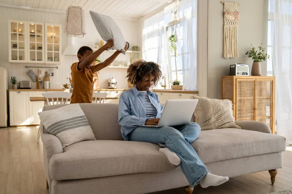 Calm Smiling African American Mother Freelancer Sits Couch Working Laptop — Stock Photo, Image