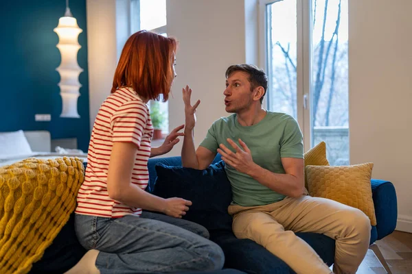 Stressed European Millennial Couple Quarreling Arguing Emotionally While Sitting Sofa — Stock Photo, Image