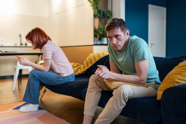 Unhappy Anxious Man Husband Sitting Sofa Feeling Annoyed Wife Smartphone — Stock Photo, Image