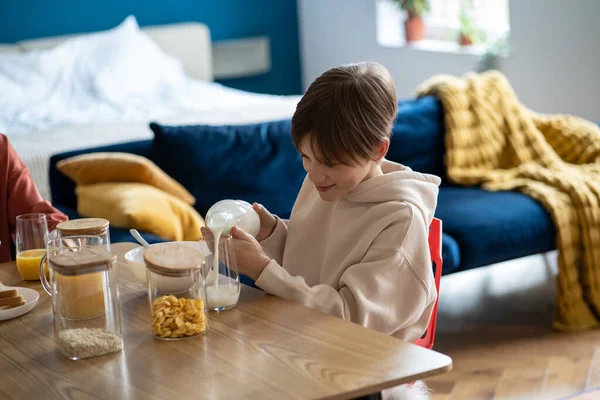 Smiling Child Schoolboy Pouring Milk Glass While Having Healthy Breakfast — Stock Photo, Image