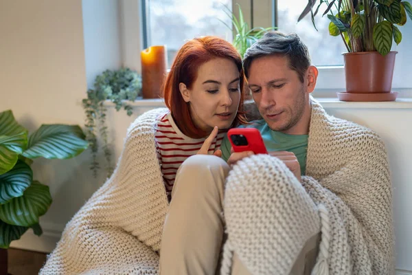 Unga Gifta Par Sitter Golvet Man Håller Smartphone Och Diskuterar — Stockfoto
