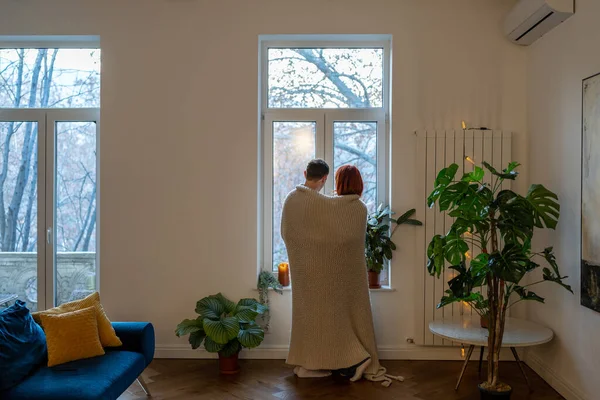 Муж Семейной Пары Обнимается Глядя Окно Стоящее Гостиной Дома Покрытое — стоковое фото