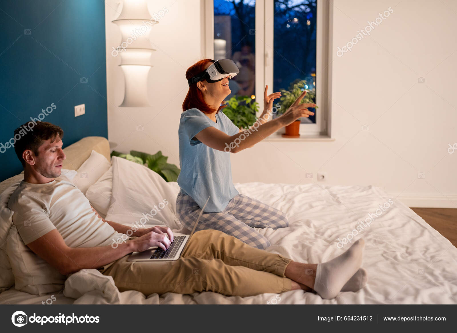 Focused Boyfriend Sits Bed Laptop Girlfriend Playing Video Game Wearing —  Stock Photo © Dimaberlin #664231512