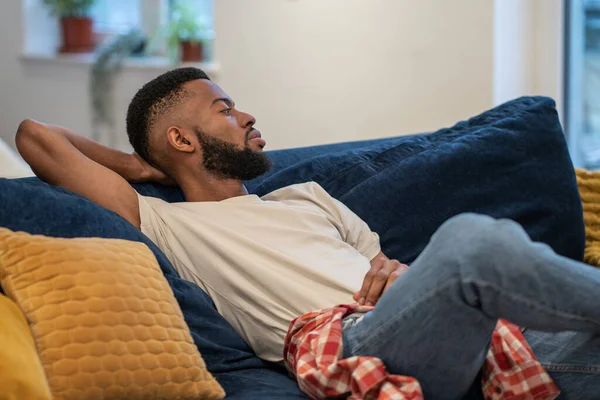 Tired Pensive Black Man Relaxing Comfortable Couch Enjoying Lazy Weekend — Stock Photo, Image