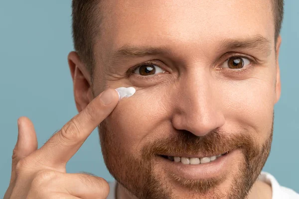Pleased Handsome Man Applying Skincare Lotion Product Face Attractive Male — Stock Photo, Image