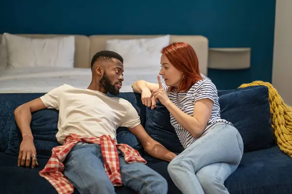 African american man caucasian woman discussing problems in relationships. Husband attentively listening wife explaining difficulties gesturing hands. Misunderstanding, attempt to resolve conflict.