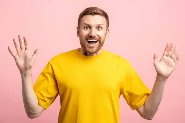 stock image Glad happy laughing man with wide opened eyes overjoyed with career promotion, lottery win, jackpot hit, great success. Amazed excited man joyfully looking at camera isolated on pink background