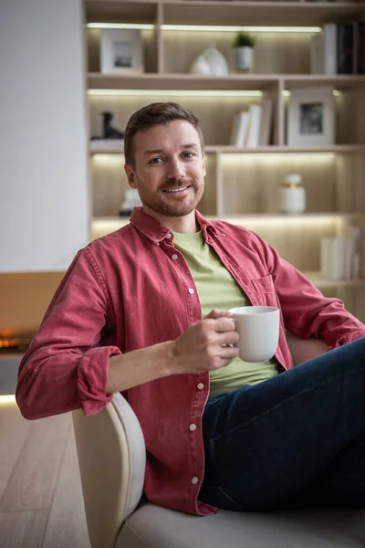 Happy Satisfied Man Holding Mug Tea Sitting Chair Looking Camera — Stock Photo, Image