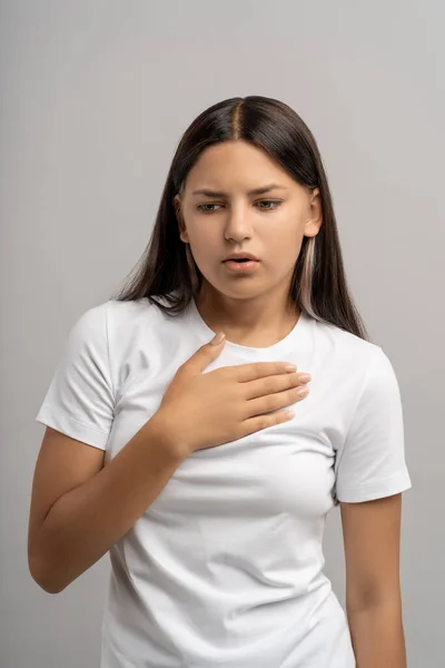 Teen Girl Feeling Relief Touching Chest Hand Looking Calm Face — Stock Photo, Image