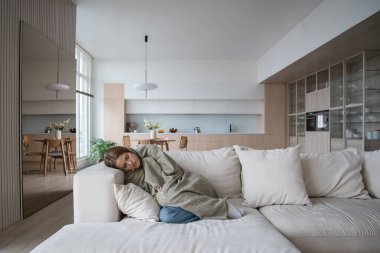 Frustrated young woman lying on couch at home suffering from heartbreaking divorce. Girl feeling bad, apathy hiding from society in loneliness solitude. Mental disorder, anhedonia, stress, sleepiness. clipart