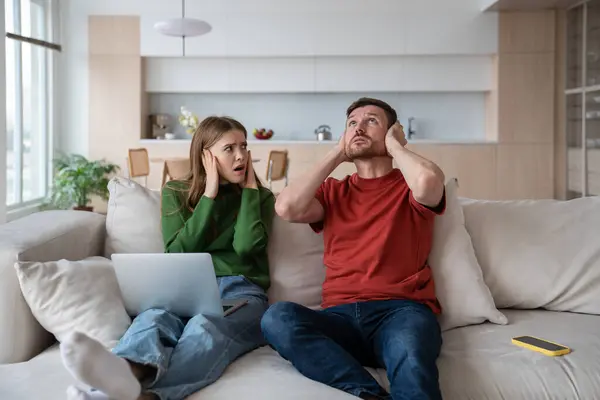 Exhausted Irritated Couple Sitting Sofa Ears Closed Because Unpleasant Nervous — Stock Photo, Image