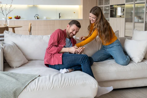 Cheerful Girlfriend Tickling Laughing Sensitive Boyfriend Home Loving Couple Spending — Stock Photo, Image