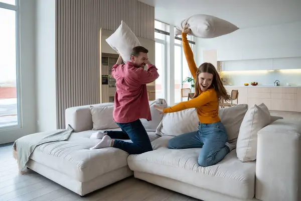 Happy Couple Laugh Joyfully Having Fun Pillow Fight Sofa Living — Stock Photo, Image