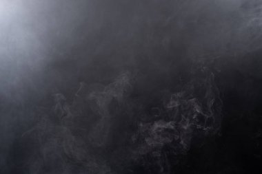 Beyaz Duman ve Sis 'ten Yoğun Kabarık Kabarık Tütsüler Siyah Arkaplan' da, Soyut Duman Bulutları 'nda, Hareketin Odak Noktası Bulanık. Kuru buz sineğinin dumanı havada uçuşuyor, dokuyu etkiliyor.