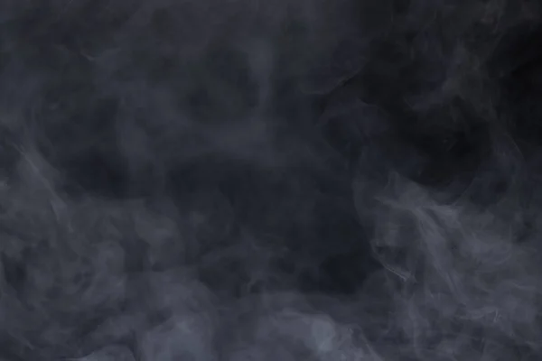 Dense Fluffy Puffs of White Smoke and Fog on black Background, Abstract Smoke Clouds, Movement Blurred out of focus. Smoking blows from machine dry ice fly fluttering in Air, effect texture