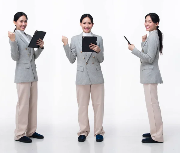 Full Length 20s Asian Woman wear formal business blazer suit  dress pant shoes. Black long straight hair female hold tablet work confident, walking forward turn left right, white background isolated
