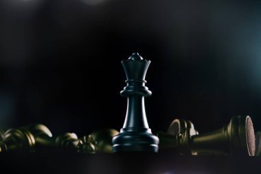 Queen Chess is winner of all chessboard competition fight. Concept Normal regular people can win and success in Business with strategy and plan while other character fall down, copy space clipart