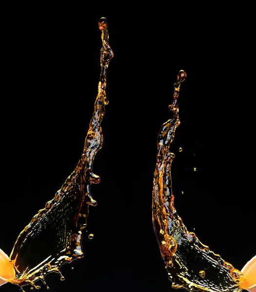 柠檬汁或润滑油飞溅 金黄色液体饮料滴落 水果饮料中的水元素呈直线状 新鲜的飞溅和流动的射流 黑色背景隔离冻结运动 — 图库照片