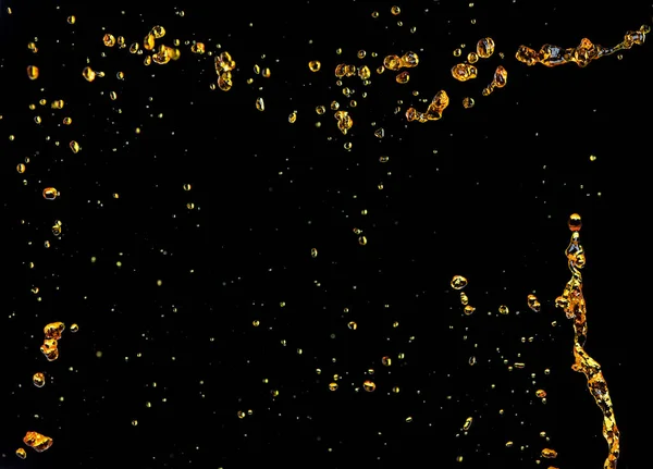 Orange, lemon juice or oil lubricant splash, liquid gold yellow drink drops. Fruit beverage water elements in line form . Fresh splashing and flowing jets, black background isolated freeze motion