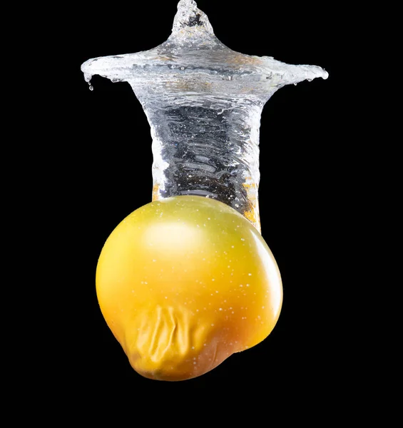 Water balloon explosion splashing in form shape, is power refreshing freshness concept. Waters Balloon explode and droplet spill all around with freeze high speed shot in black background studio