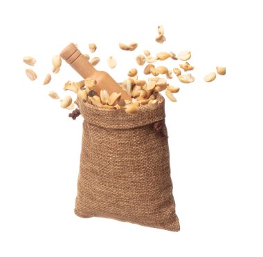 Roasted Peanut bean fall throw up in sack bag, Roasted Peanut bean float explode, abstract cloud fly. Roasted Peanut beans splash throwing in Air. White background Isolated high speed shutter, freeze