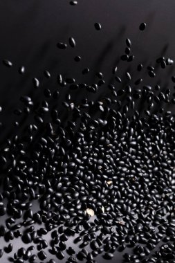 Black Bean flying explosion, black grain beans explode abstract cloud fly. Beautiful complete seed pea bean splash in air, food object design. Black background high speed shutter freeze motion