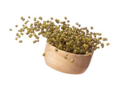 Green mung beans fly throw up in wooden bowl, green mung bean float explode, abstract cloud fly. Dried green mung beans splash throwing in Air. White background Isolated high speed shutter, freeze