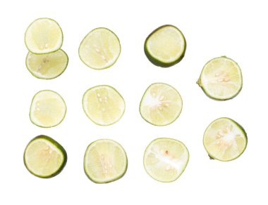 Sliced Green Lime fly explosion, many round green lime fall down fruit. group of Tropical green lime with rough natural inside throw in air. White background Isolated high speed shutter, freeze action