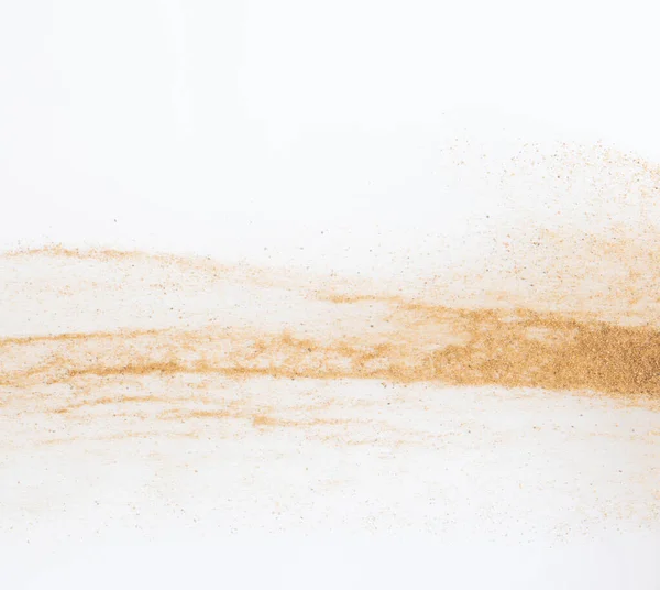 Sand flying explosion, Golden sand wave explode. Abstract sands cloud fly. Yellow colored sand splash throwing in Air. White background Isolated selective focus, throwing motion Blur