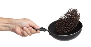 Black Pepper seeds fly throw up in pan, Black Pepper float explode, abstract cloud fly. Black Peppercorn splash throwing in Air. White background Isolated high speed shutter, freeze motion