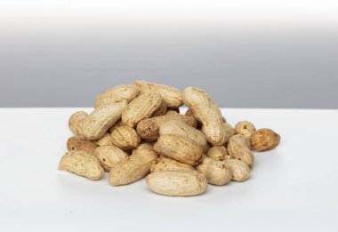 Pile group of boiled peanut, boiled peanut bean fall down pour on ground. Tropical boiled peanut shot close up. White background Isolated high speed shutter, freeze action