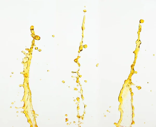オレンジ レモン汁や油潤滑油スプラッシュ 液体金黄色のドリンクが値下がりしました 果物飲料水の要素の行の形で 新鮮な飛沫と流れるジェット 白い背景隔離された凍結運動 — ストック写真