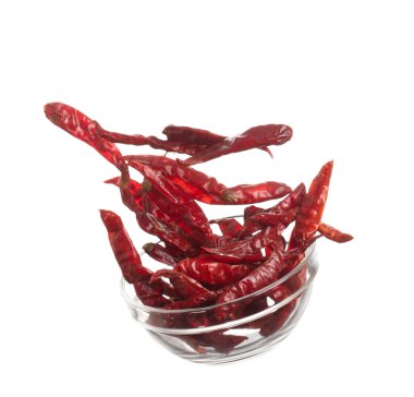 Dried Red hot Chilli fall down in Glass Bowl, dried Red Chilli float explode, abstract cloud fly. Dried Red hot Chillis splash throwing in Air. White background Isolated high speed shutter, freeze