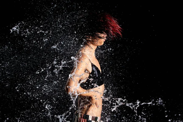 stock image Tanned skin Asian woman in bikini poses in aqua studio. Splash Drops of water spread to body. Fun emotion female girl on water attack fluttering and stop motion freeze shot, black background isolated