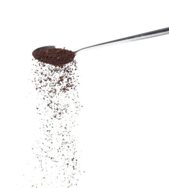 Coffee powder fall down pour in spoon, Coffee crushed float explode, abstract cloud fly. Coffee dust powder splash throwing in Air. White background Isolated high speed shutter, freeze motion