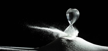 Kum saati siyah arka planda beyaz kuma daha fazla zaman kazandırır. Beyaz kum saati daha fazla zaman gösteriyor. Süresi uzatılmış zaman yönetimi konsept saat camı, hayat saati geçiyor.